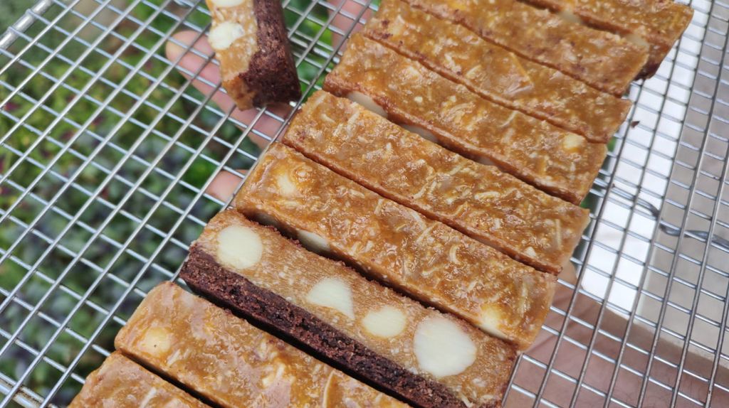 All natural sustainable chocolate bars with macadamia, caramel, and honey. Artisanal wellness snack.