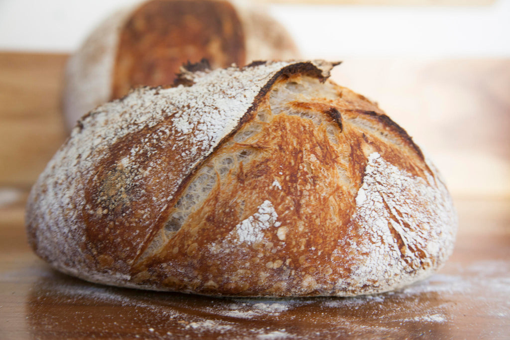Country-style sourdough bread loaf. Naturally fermented for improved digestion and better blood sugar control wellness.