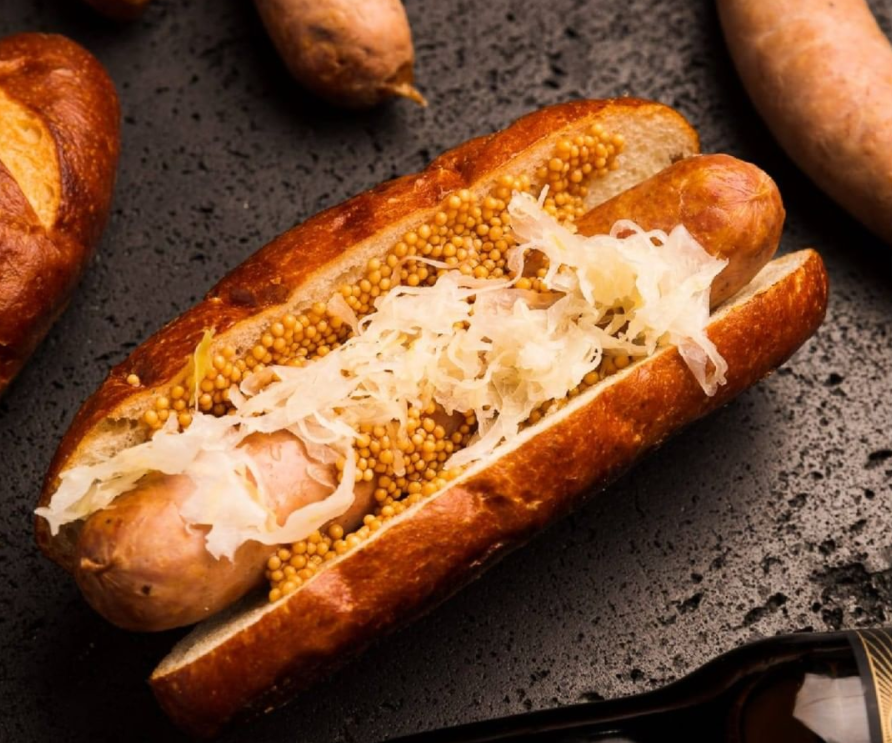 Moist, fluffy, flavorful artisanal pretzel hot dog buns by Panito, perfect for specialty sausages.
